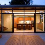 Broadview Residence Remodel/Addition of a mid-century home. Indoor/Outdoor space is formed by the use of a commercial storefront window system with large sliding doors. Concrete flooring with radiant heat extend from inside out. Flush IPE decking in the concrete patio further delineate the outdoors
